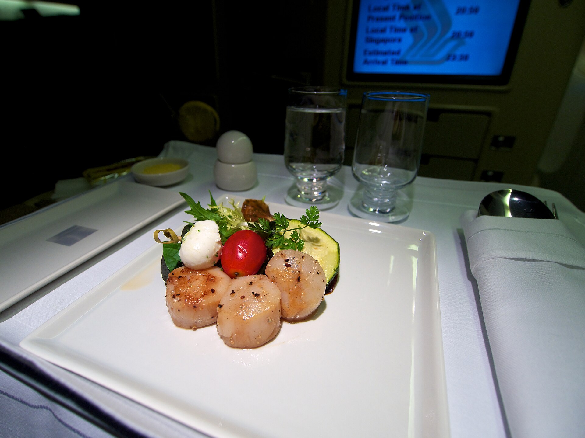 A plated business-class starter on a white tablecloth