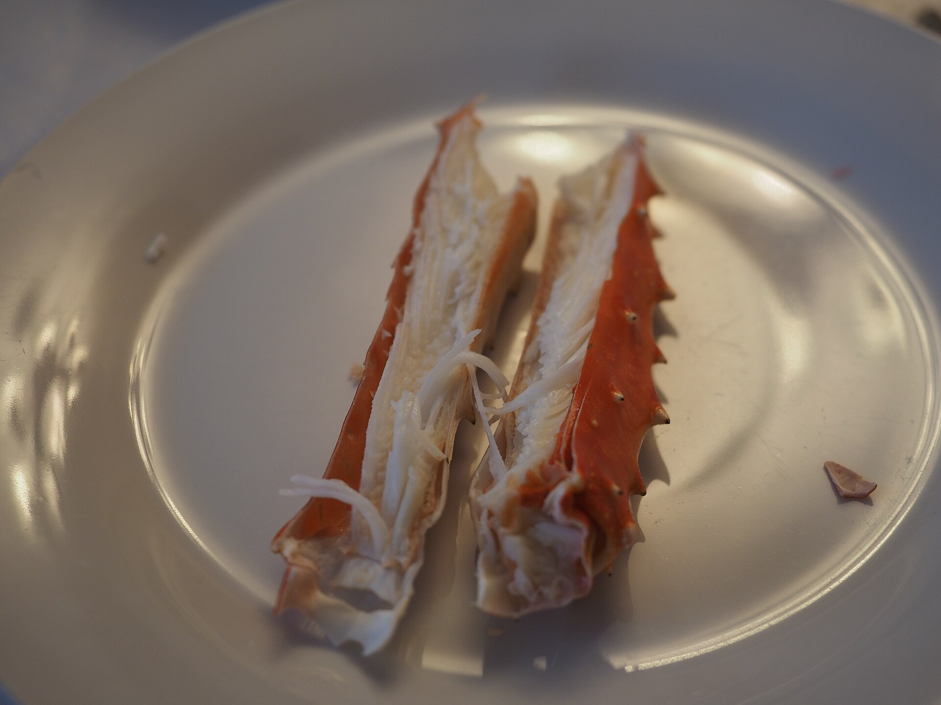 An opened king crab leg on a plate